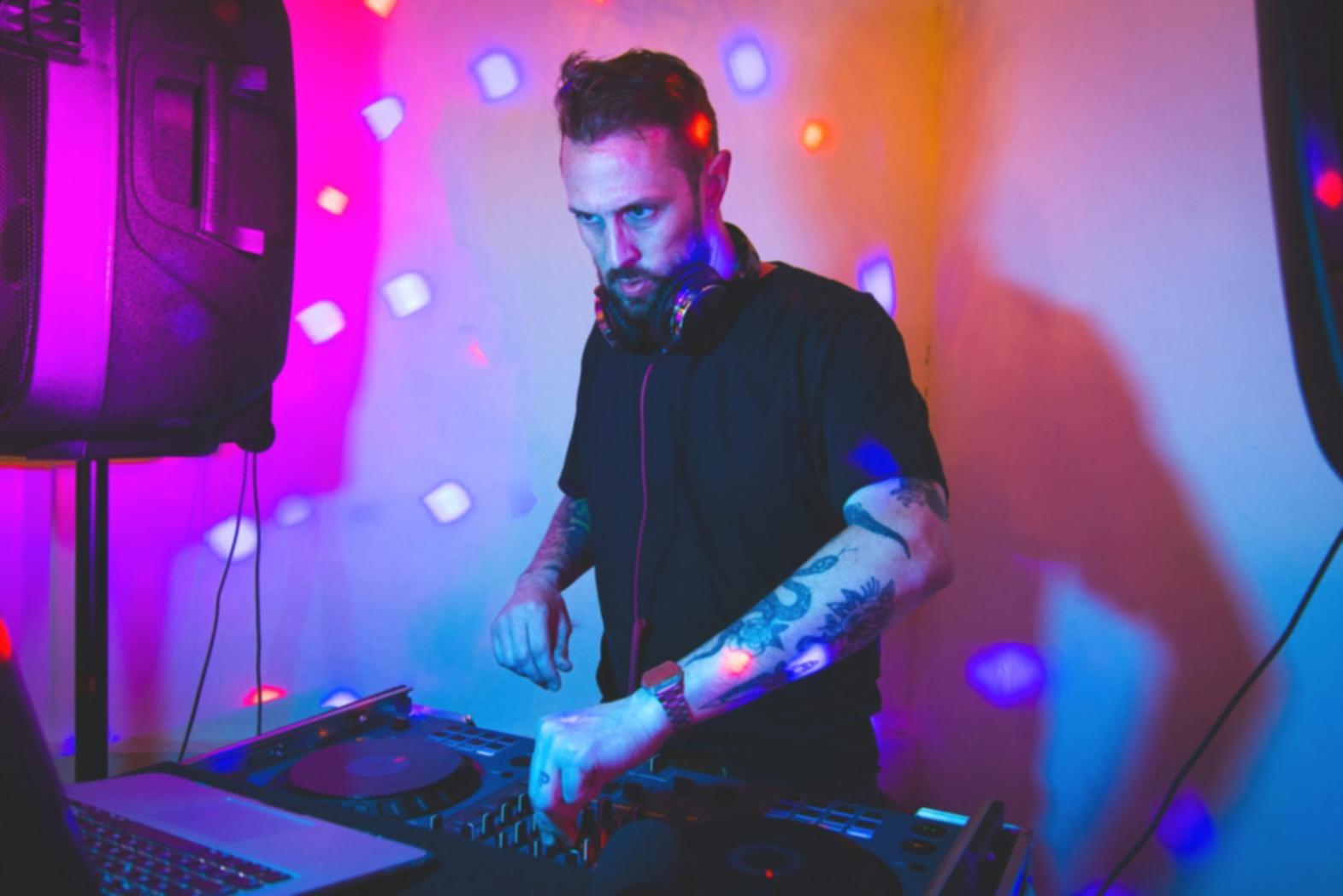 Audio engineer working with mixing console and monitoring equipment